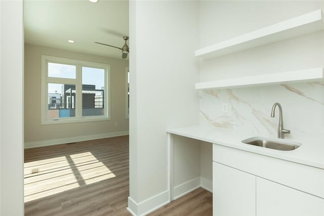 bar featuring backsplash, white cabinets, sink, dark hardwood / wood-style floors, and ceiling fan