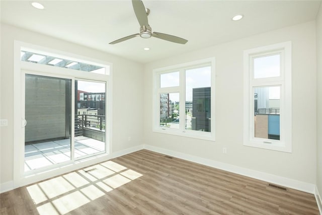 unfurnished room featuring hardwood / wood-style flooring and ceiling fan