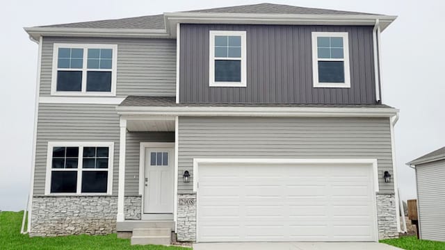 view of front of house featuring concrete driveway, a garage, stone siding, and a shingled roof