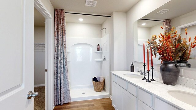 bathroom featuring vanity, hardwood / wood-style floors, and curtained shower