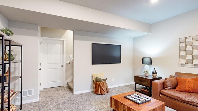 living area with stairs, visible vents, carpet, and baseboards