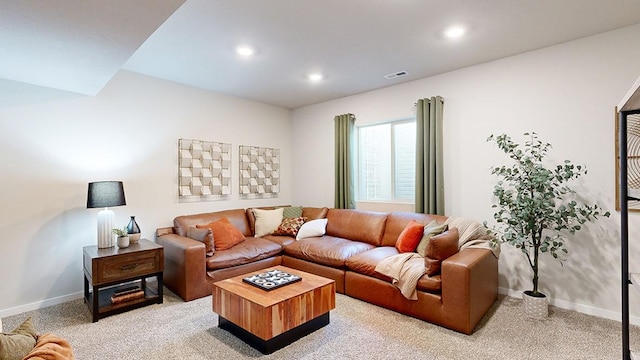 living area with recessed lighting, visible vents, baseboards, and light colored carpet