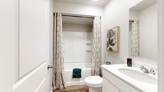 bathroom featuring vanity, shower / bath combination with curtain, toilet, and wood finished floors