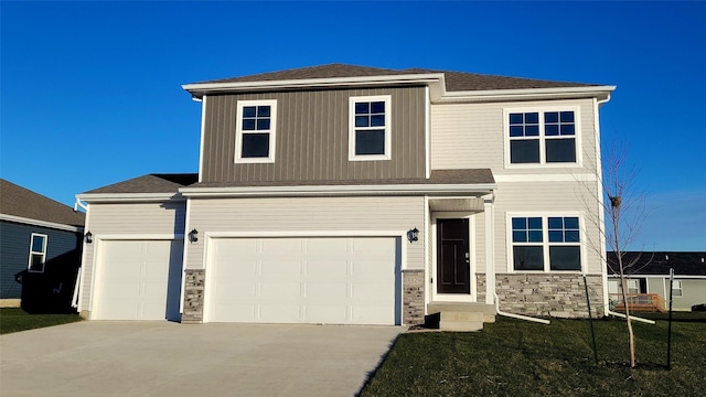 view of front of property with a front lawn and a garage