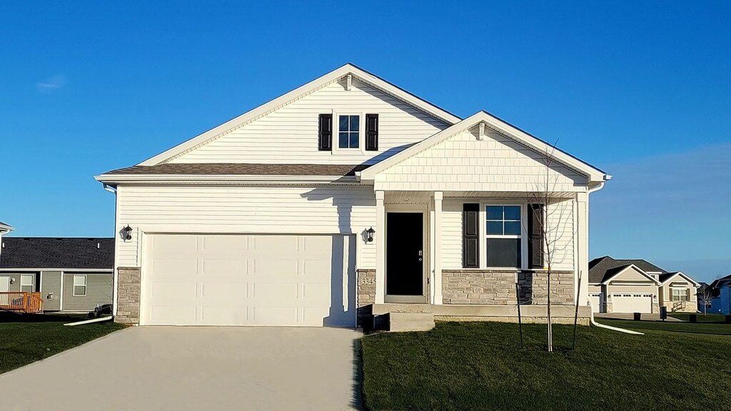 view of front of property with a front yard and a garage