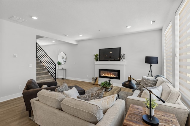 living room with beam ceiling and hardwood / wood-style floors