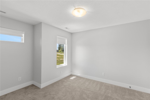 empty room featuring light colored carpet