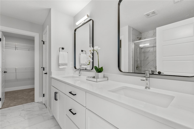 bathroom with vanity and a shower with shower door