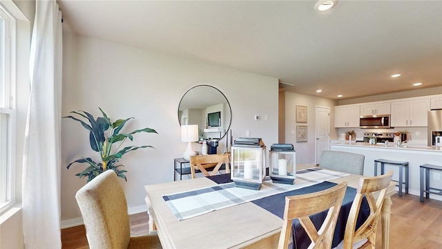 dining area with plenty of natural light and light wood-type flooring