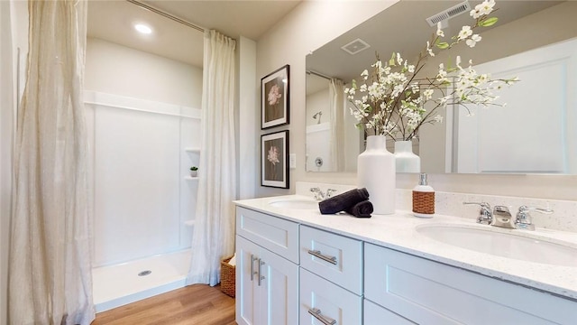 bathroom with vanity, a shower with shower curtain, and hardwood / wood-style flooring