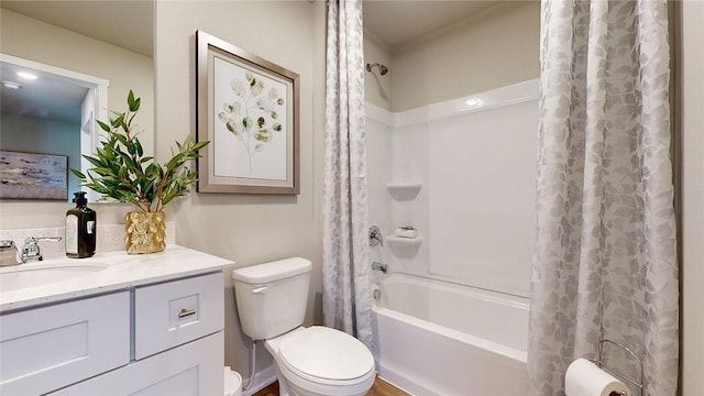 full bathroom featuring shower / bath combo with shower curtain, vanity, and toilet