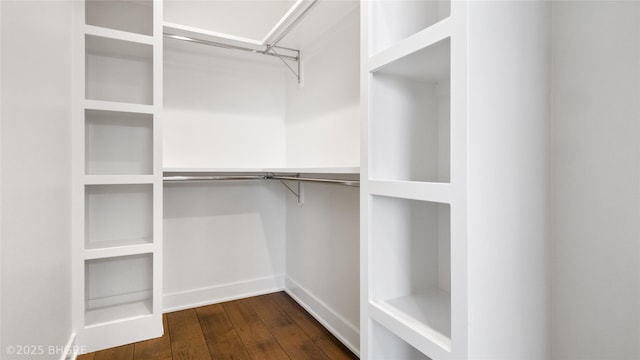 spacious closet with dark wood-style floors