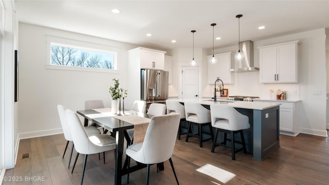 dining room featuring dark wood-type flooring, recessed lighting, and baseboards