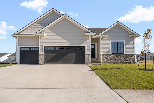 craftsman house with a front yard and a garage