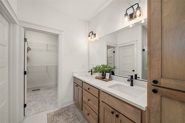 bathroom featuring tile patterned flooring and vanity