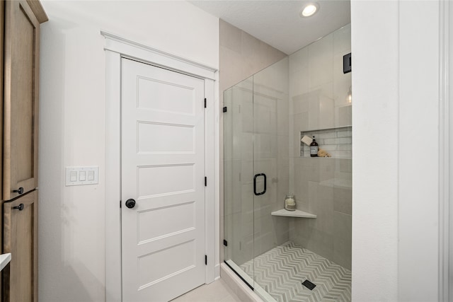 bathroom with a shower with door