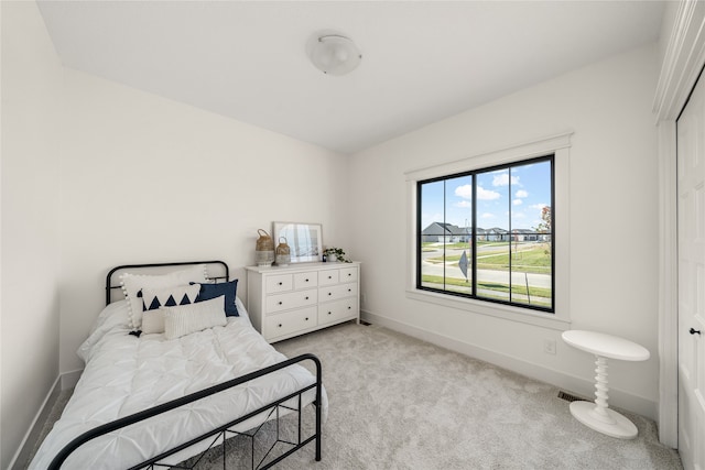 bedroom with light colored carpet