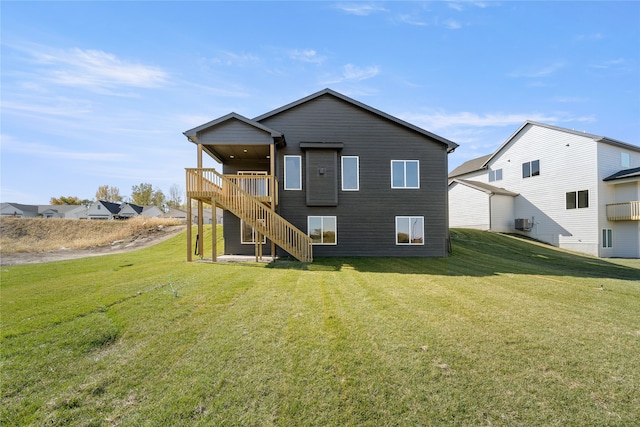 back of property with a lawn and a wooden deck