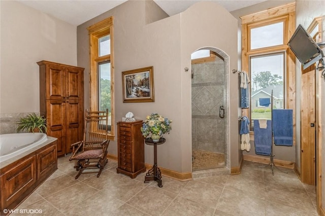 bathroom featuring separate shower and tub and a towering ceiling