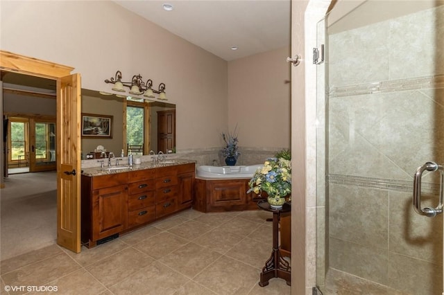 bathroom with tile patterned floors, vanity, and separate shower and tub