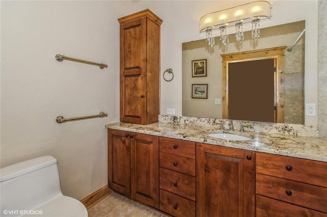 bathroom with tile patterned flooring, vanity, and toilet