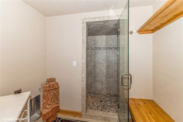 bathroom featuring a textured ceiling and walk in shower