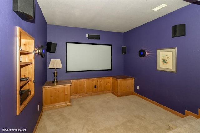 carpeted cinema featuring built in shelves