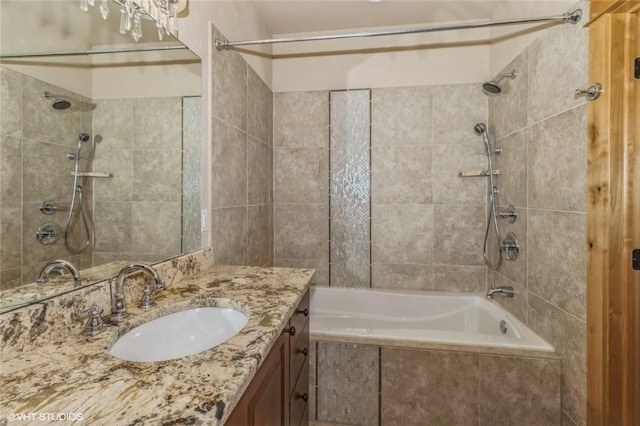 bathroom featuring vanity and tiled shower / bath