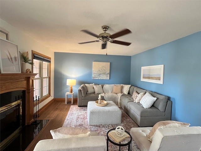 living room featuring ceiling fan and dark hardwood / wood-style flooring