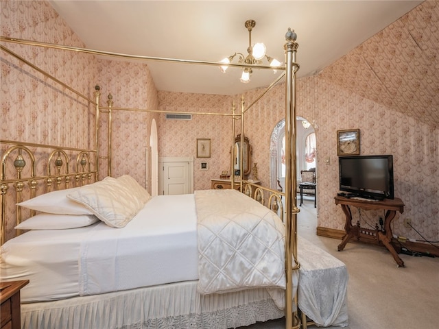 bedroom featuring a chandelier, lofted ceiling, and carpet floors