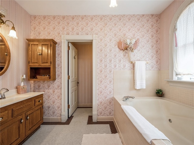 bathroom with plenty of natural light, vanity, tile patterned floors, and tiled bath