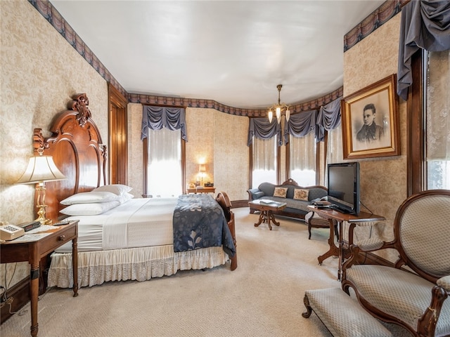 bedroom with carpet flooring and an inviting chandelier