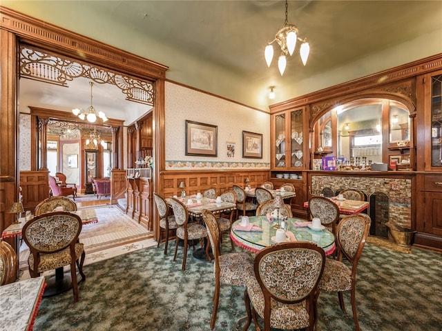 carpeted dining space featuring a notable chandelier