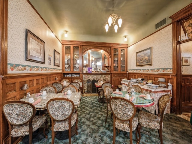 dining space featuring an inviting chandelier and carpet flooring