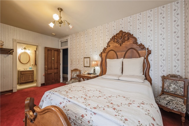 bedroom featuring a notable chandelier, carpet, and connected bathroom