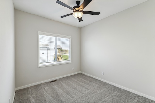 empty room with ceiling fan and carpet floors