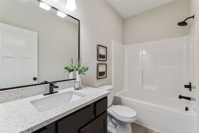 full bathroom with vanity, hardwood / wood-style floors, shower / bathtub combination, and toilet