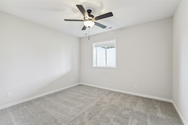 unfurnished room featuring light carpet and ceiling fan