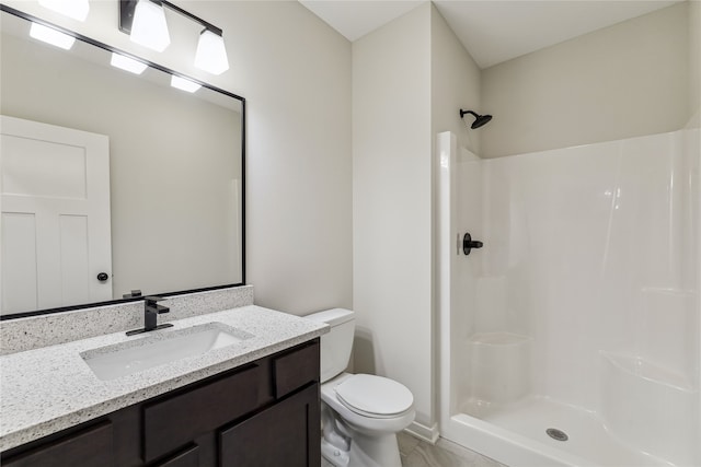 bathroom with walk in shower, vanity, and toilet