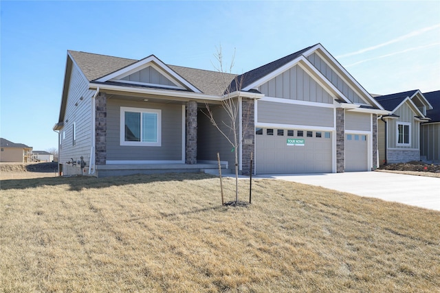 view of front of home with a garage and a front lawn