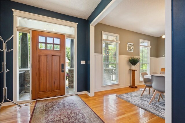 foyer entrance featuring a wealth of natural light and light hardwood / wood-style floors