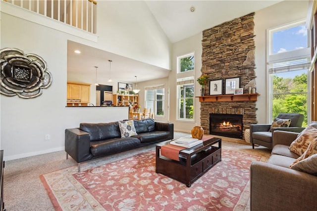 living room featuring carpet flooring, a fireplace, and high vaulted ceiling