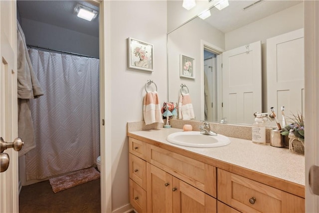 bathroom with toilet and vanity