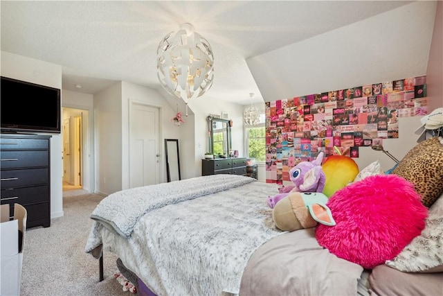 carpeted bedroom with an inviting chandelier