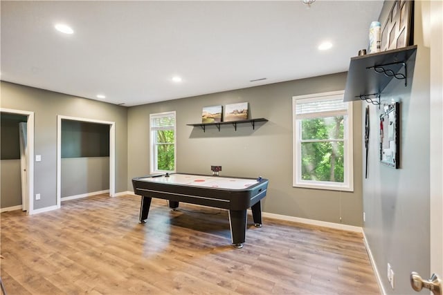 recreation room featuring a healthy amount of sunlight and light hardwood / wood-style floors