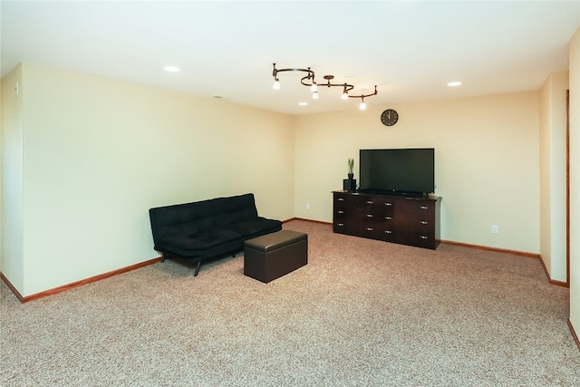 sitting room with carpet floors and rail lighting