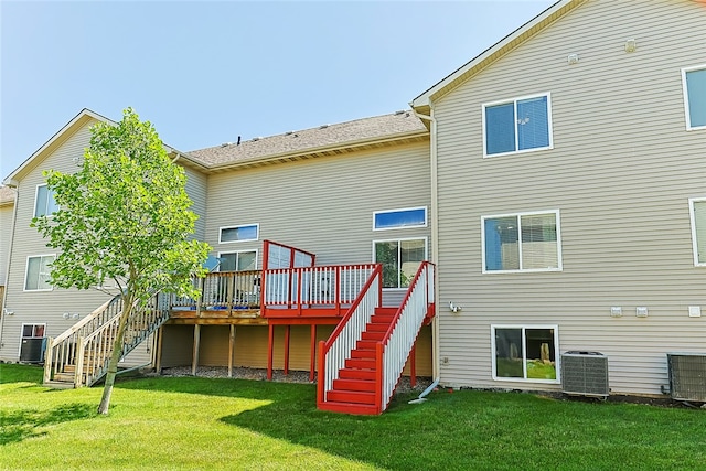 rear view of property with a deck, a yard, and central AC unit