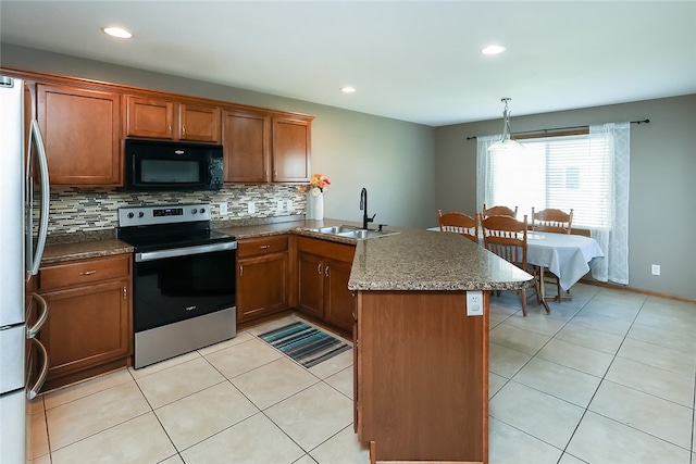 kitchen with light tile patterned floors, appliances with stainless steel finishes, decorative backsplash, decorative light fixtures, and sink