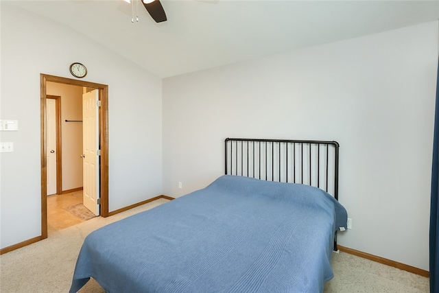 carpeted bedroom featuring vaulted ceiling and ceiling fan