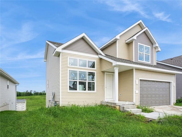 view of front of home with a front yard and a garage